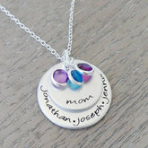 Personalized mom necklace with engraved names and colorful birthstone charms on a silver chain.