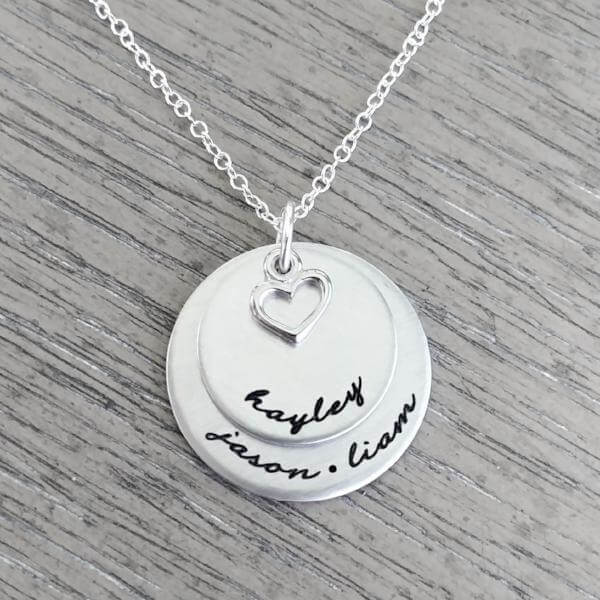 Personalized sterling silver necklace with two discs and heart charm, featuring names Kayley, Jason, and Liam.