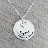 Personalized sterling silver necklace with two discs and heart charm, featuring names Kayley, Jason, and Liam.