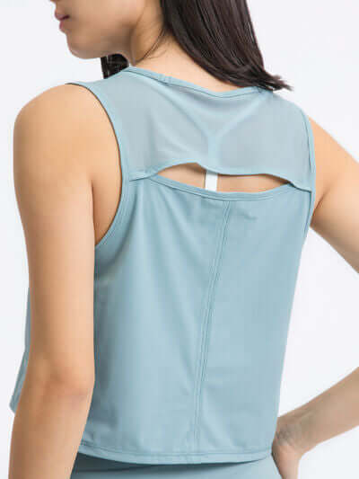 Back view of the Millennia Round Neck Cropped Active Tank in light blue, showcasing its stylish cutout design.