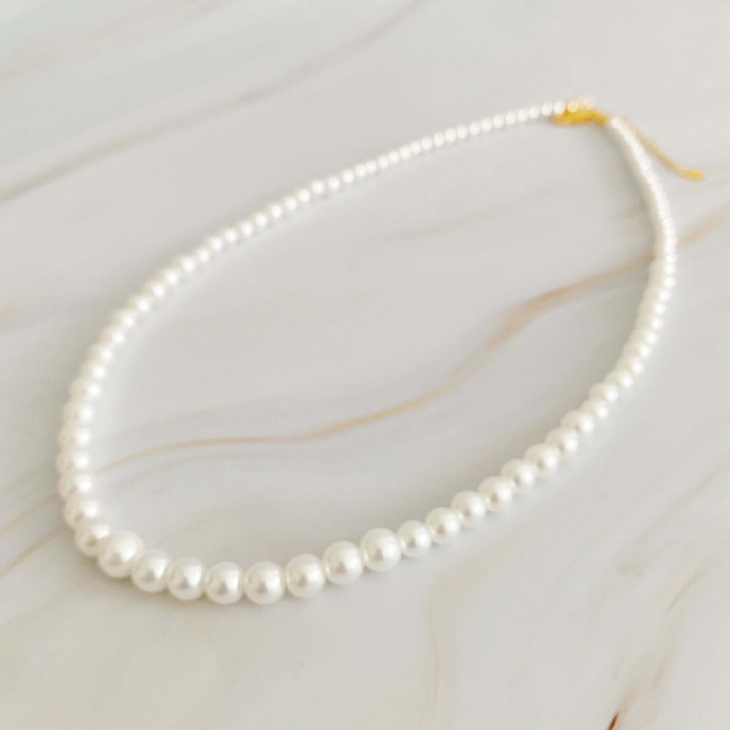 Queen Liz Graduated Pearl Necklace featuring cream-toned graduated pearls from 4mm to 7mm, 18" long with 2" extender.