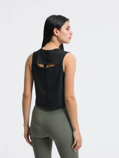 Model wearing a black Millennia Round Neck Cropped Active Tank, showcasing its back design and fit.