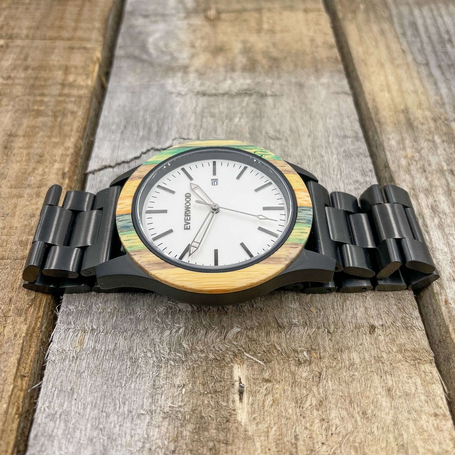 Inverness SS Multi-Colored Bamboo and Stainless Steel Watch on wooden surface, showcasing unique design and elegant craftsmanship.