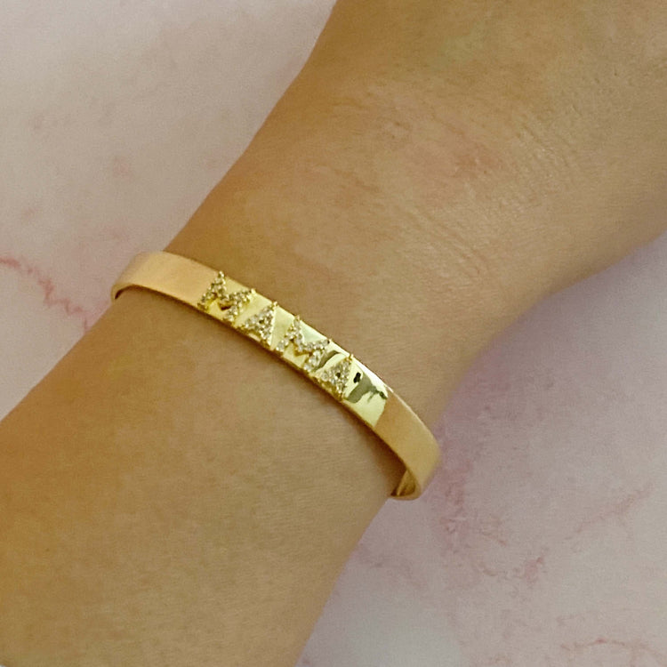 Mama Open Bangle Bracelet in 18k gold plated brass with CZs, showing elegance on wrist, dimensions 2.5 x 2 inches.