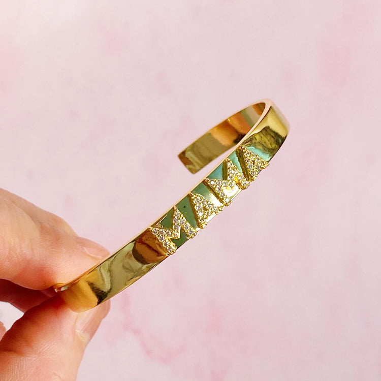 Gold Mama open bangle bracelet featuring shiny CZs, made of brass, dimensionally built for easy wear.