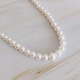 Graduated cream-toned pearl necklace featuring pearls from 4mm to 7mm, perfect for layering or as a statement piece.