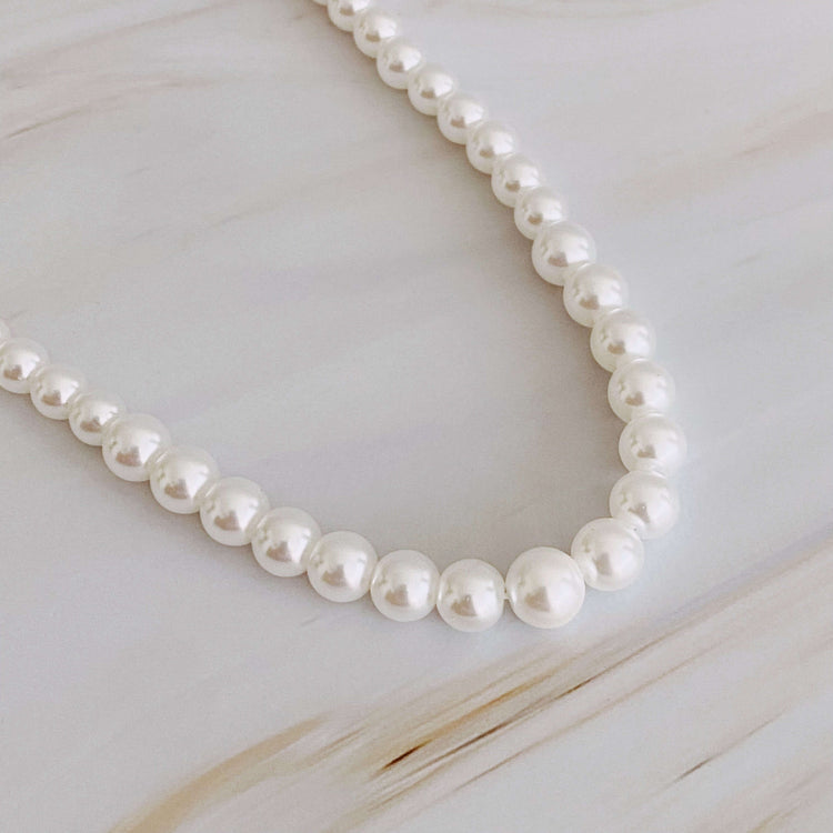 Graduated cream-toned pearl necklace featuring pearls from 4mm to 7mm, perfect for layering or as a statement piece.