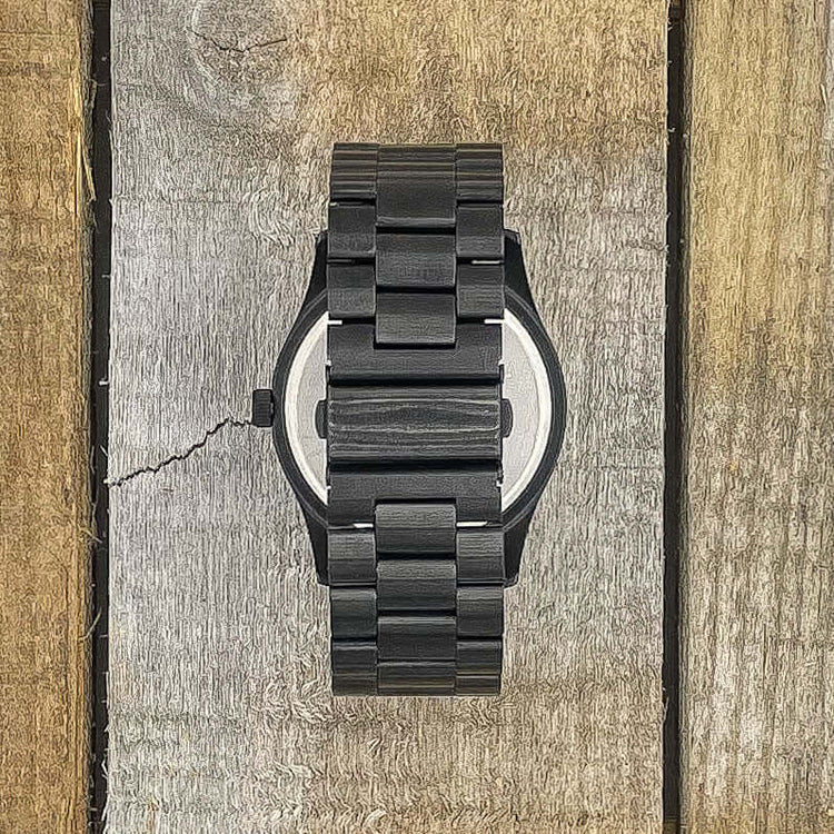 Inverness SS Multi Bamboo watch displaying a black stainless steel strap on a rustic wooden background.