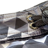 Close-up of Sustainable Surf Geometric Gray boardshorts showcasing the unique pattern and fixed waist design.