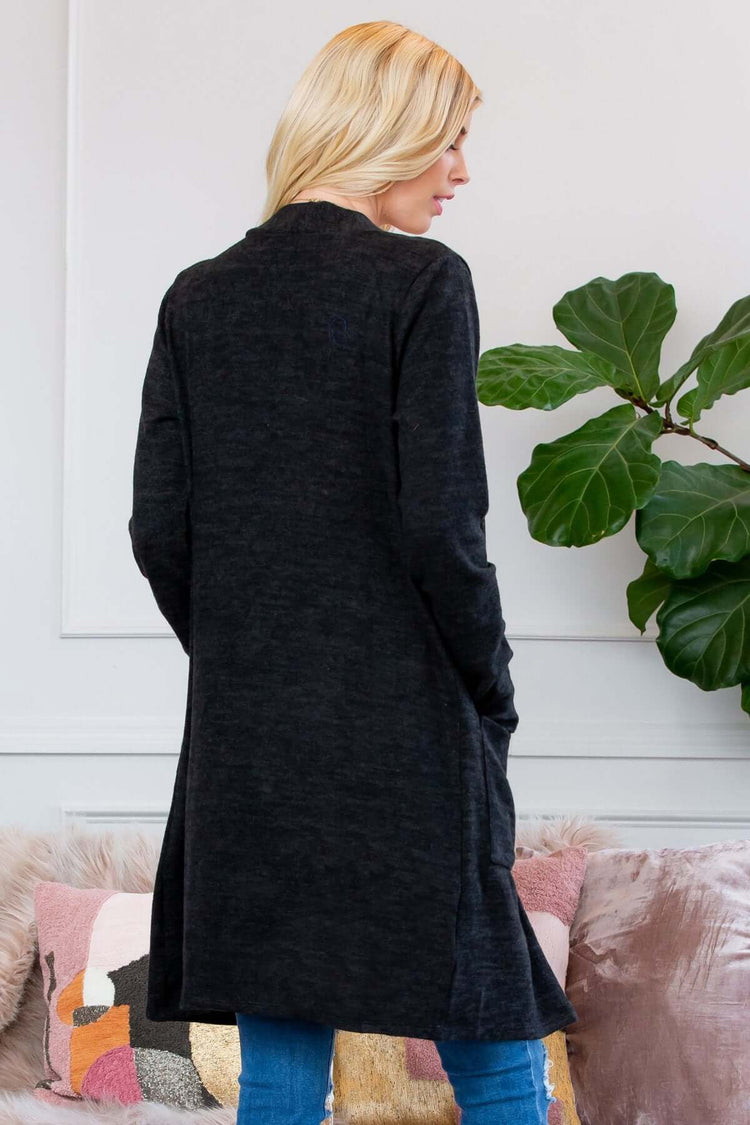 Back view of a woman wearing a soft brushed sweater pocket cardigan, perfect for cold weather layering.