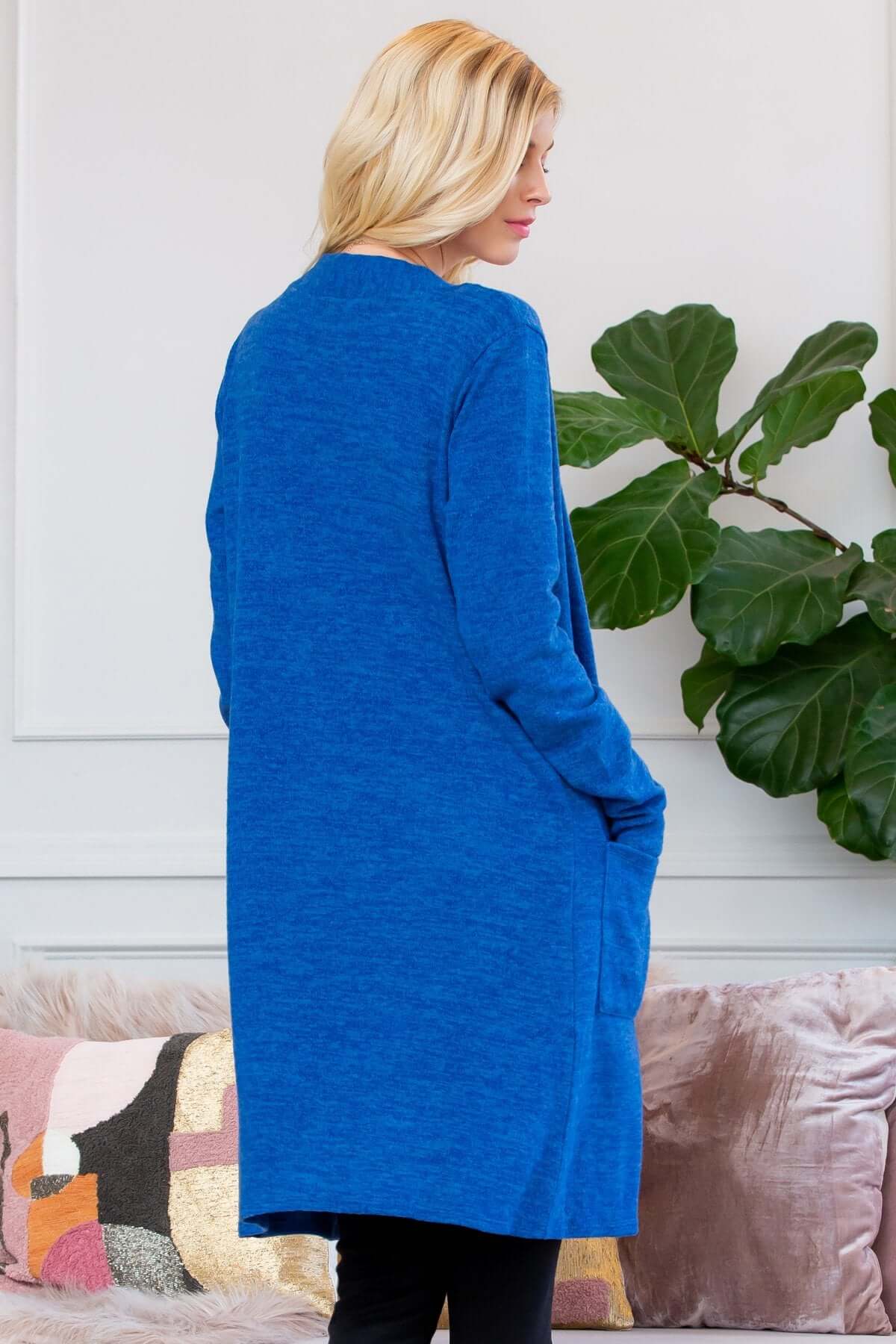 Back view of a blue brushed sweater pocket cardigan, featuring an open front and long silhouette.