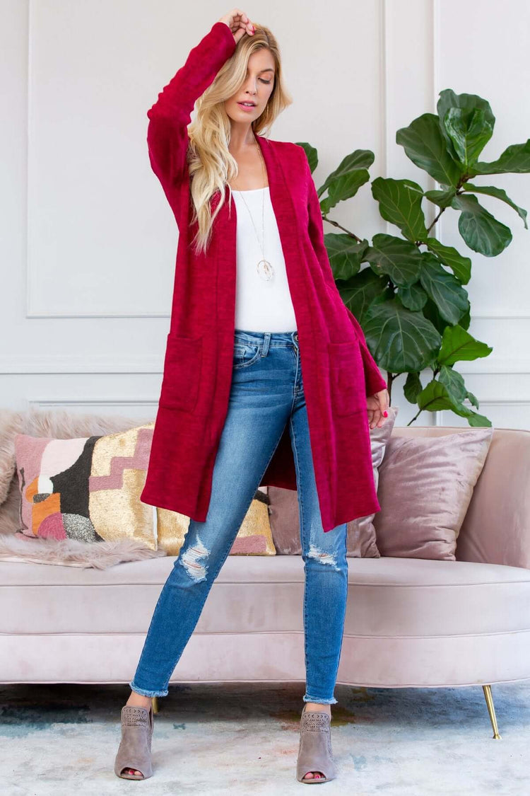 Model wearing a brushed sweater pocket cardigan in burgundy, paired with skinny jeans and ankle boots.