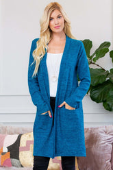 Model wearing a soft brushed sweater pocket cardigan in blue, featuring an open front and long sleeves.