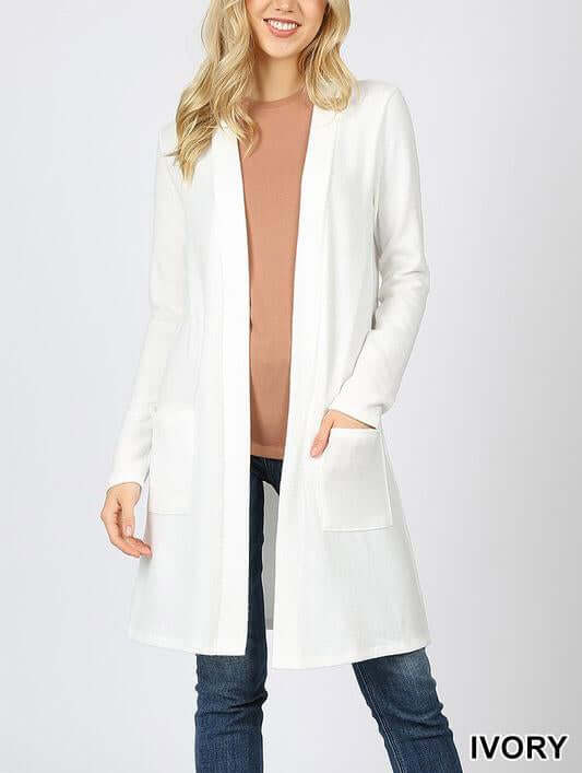 Ivory brushed sweater pocket cardigan with long sleeves, open front, and two side pockets, perfect for layering.