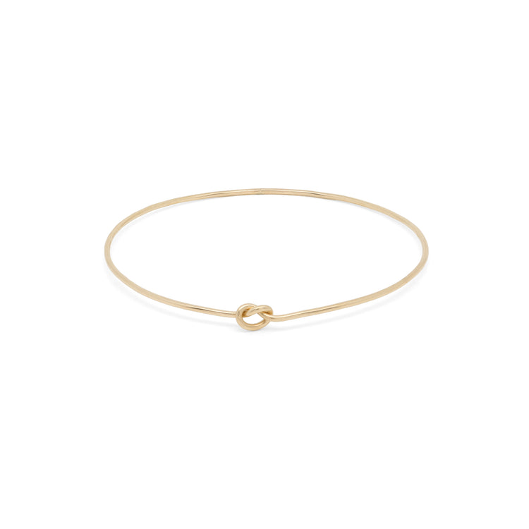 Elegant Shelby Love Knot Bangle in gold, featuring a unique knot design for a stylish accessory.