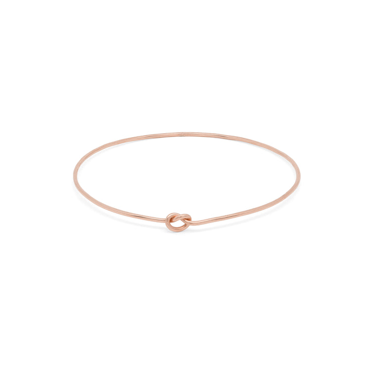 Shelby Love Knot Bangle in rose gold, featuring a unique knot design for a stylish and elegant accessory.