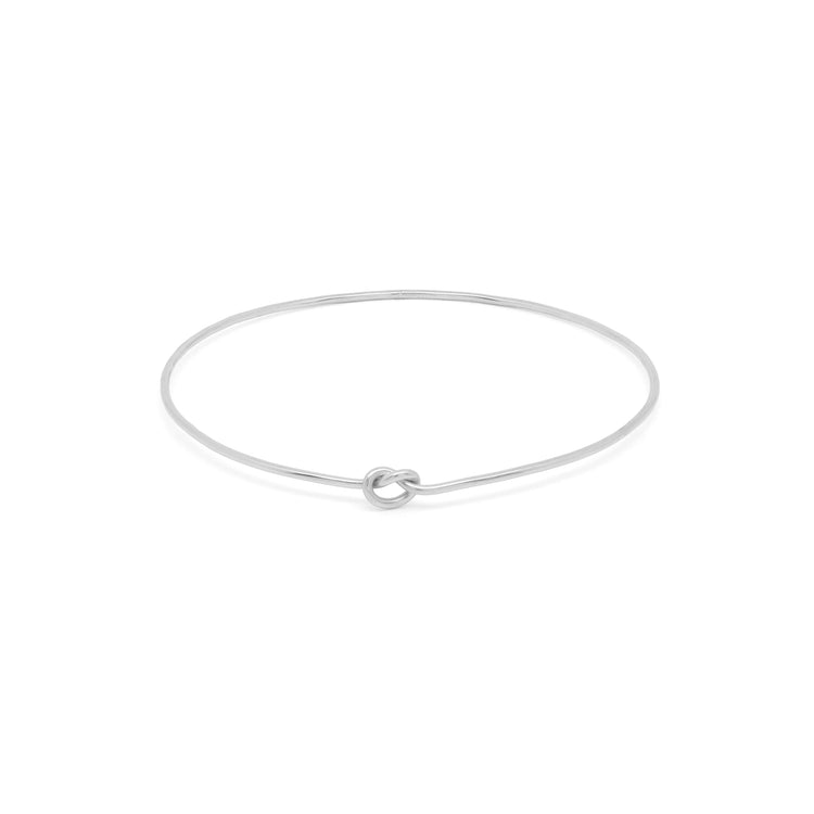 Shelby Love Knot Bangle in silver, featuring a unique knot design for a stylish and elegant accessory.
