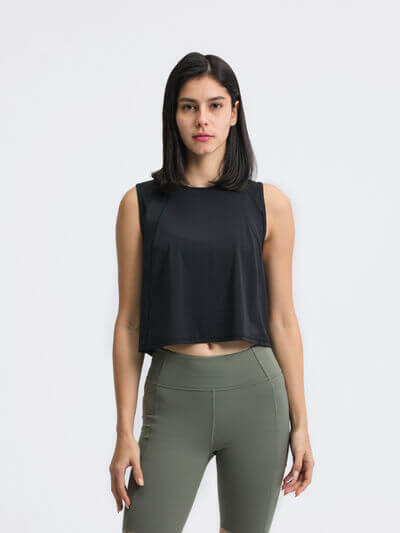 Black cropped active tank top with round neck, paired with olive green leggings for a stylish workout look.