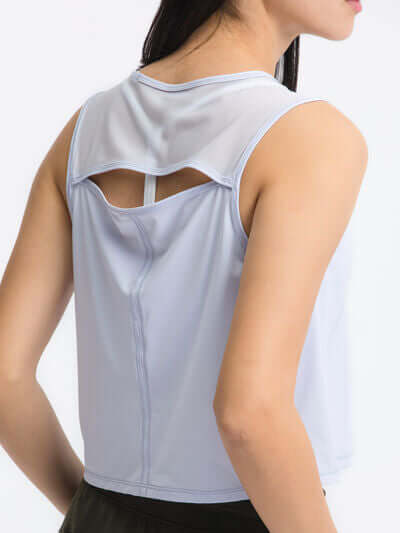 Millennia Round Neck Cropped Active Tank in light blue, showcasing sheer back detail and highly stretchy fabric.