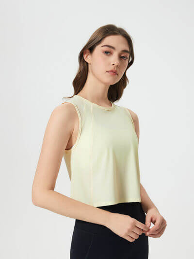 Millennia Round Neck Cropped Active Tank in soft yellow, showcasing its stretchy, comfortable fabric and sleek design.