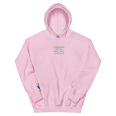 Pink unisex hoodie with green text that reads &