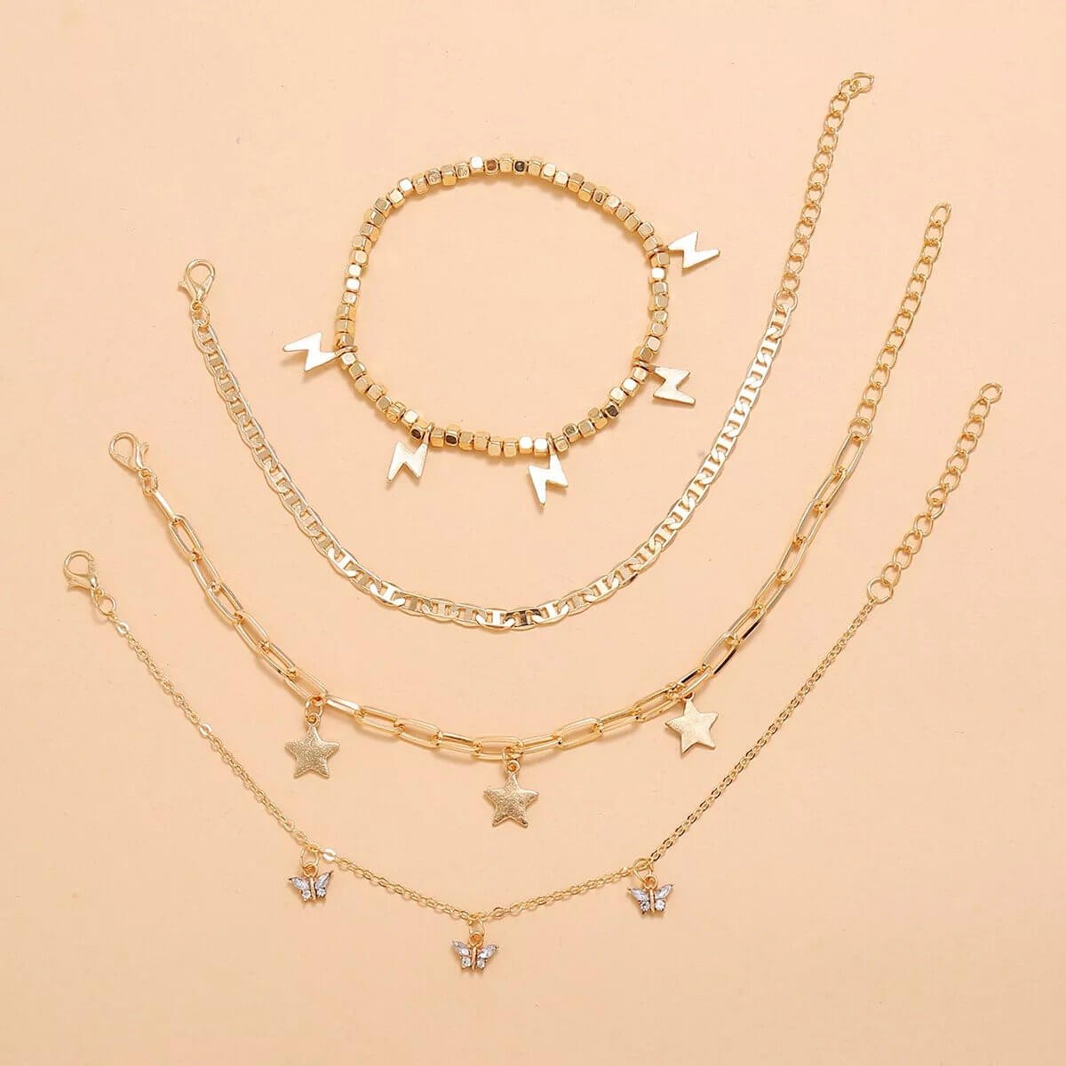 Trendy Player Anklet Set with 4 gold plated adjustable anklets, featuring stars and lightning designs.