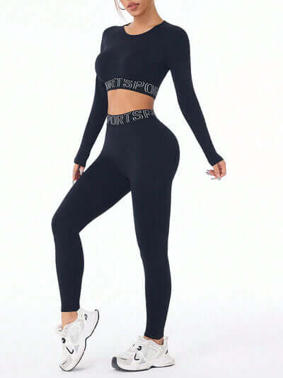 Model wearing a black letter print round neck long sleeve top and leggings active set, styled with sporty shoes.