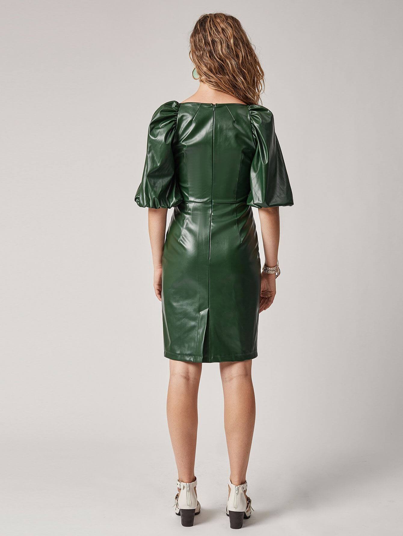 Back view of a dark green vegan leather dress with puff sleeves and a fitted silhouette.