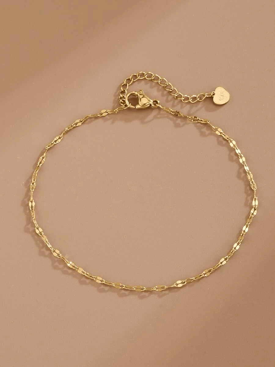 Gold anklet bracelet with chain extension and heart charm, perfect for trendy fashion styles.