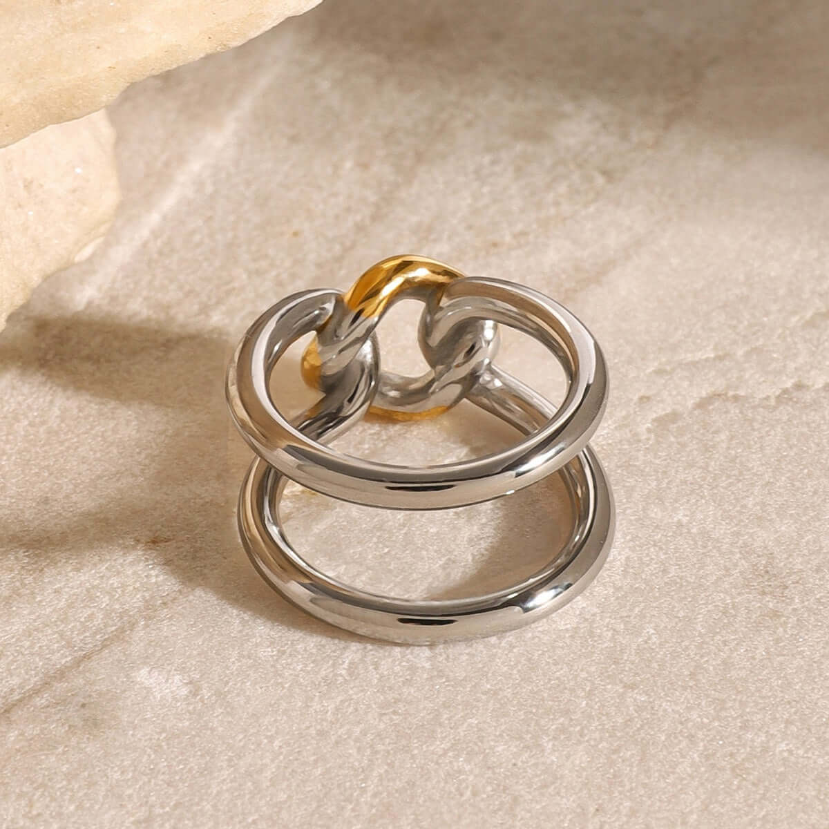 Elegant 18K gold-plated hollow ring featuring a unique gold and silver contrast design.