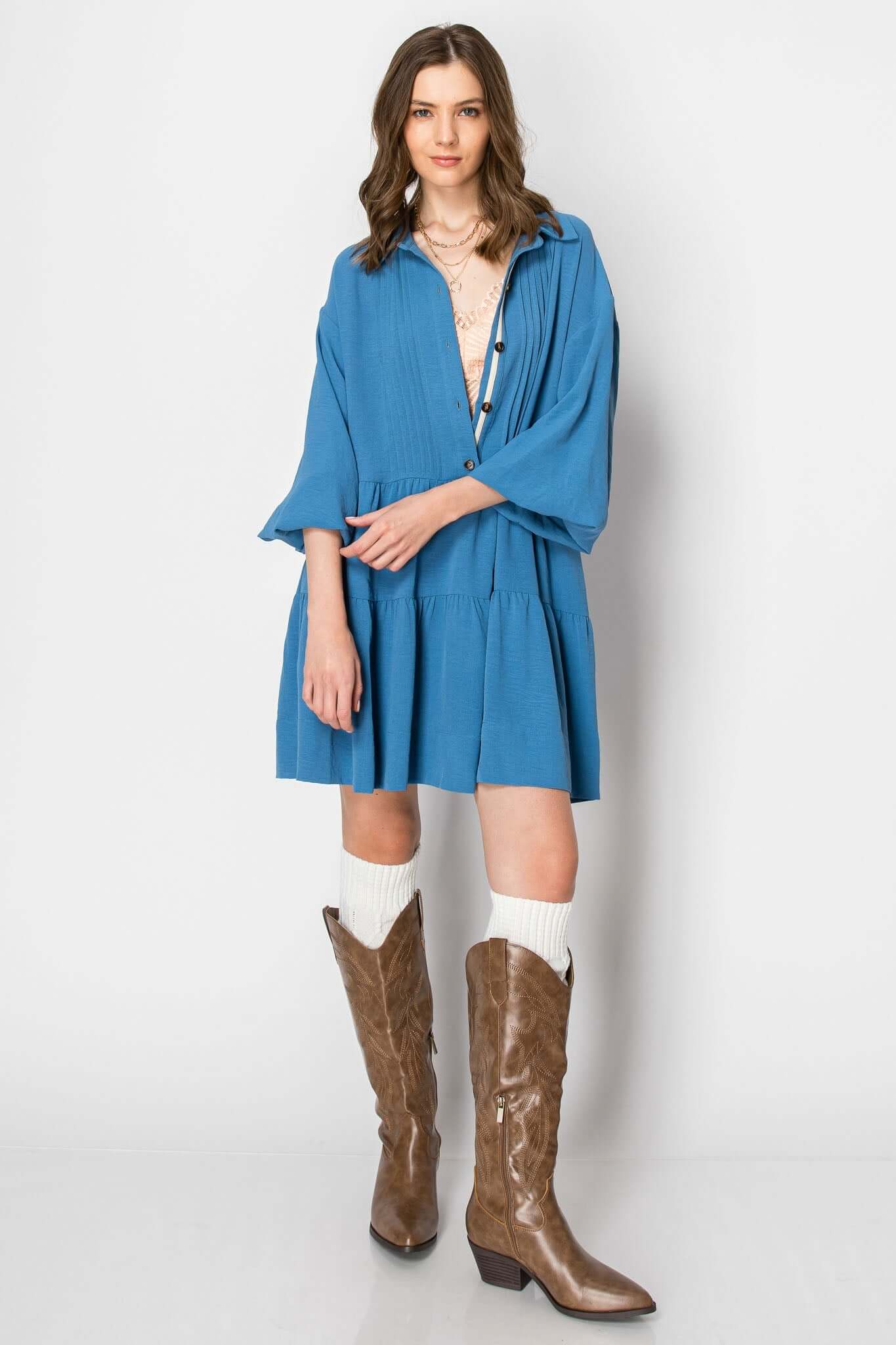 Long sleeve collared button-down dress in blue, styled with brown western boots and casual accessories.