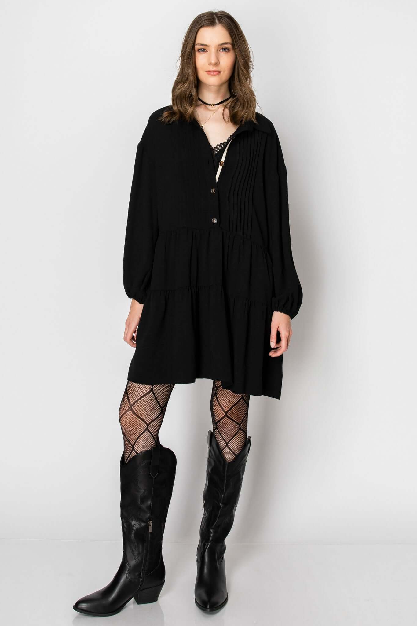 Long sleeve collared button-down tiered ruffle dress, styled with fishnet tights and western boots for a trendy fall look.