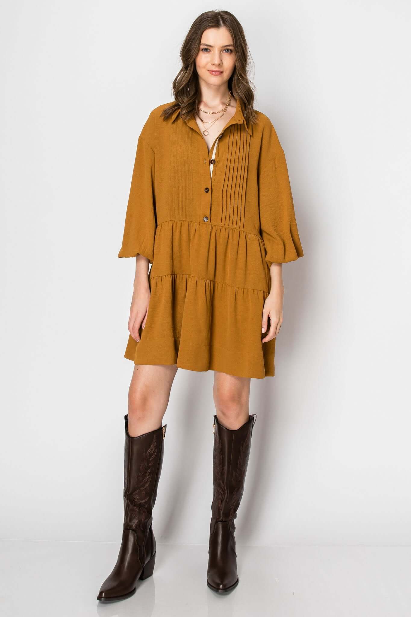 Long sleeve collared button-down tiered ruffle dress in mustard, styled with western boots, perfect for fall casual wear.