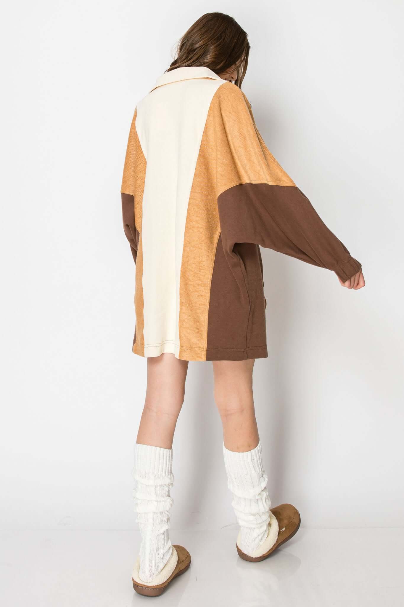 Back view of a color block long sleeve collared mini dress in tan and brown with pockets, styled for fall.