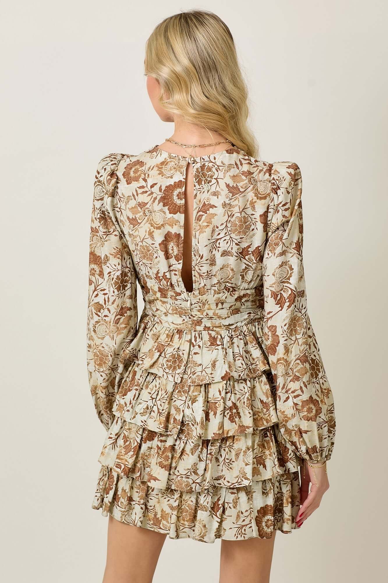 Floral print ruffle long sleeve dress featuring a tiered design and elegant back detail.