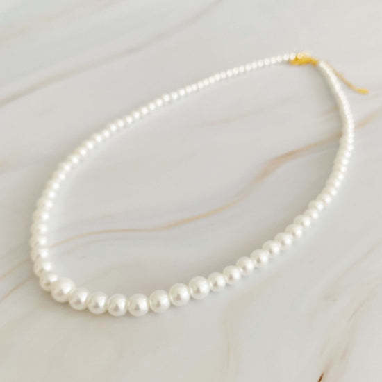 Queen Liz Graduated Pearl Necklace featuring cream-toned graduated pearls from 4mm to 7mm, 18" long with 2" extender.