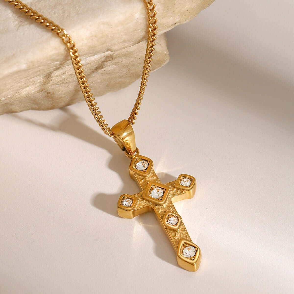 18K gold-plated cross pendant necklace with diamond inlay, showcasing elegance and luxury on a neutral background.