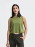 Model wearing olive green Millennia round neck cropped active tank top, showcasing stylish activewear for workouts.