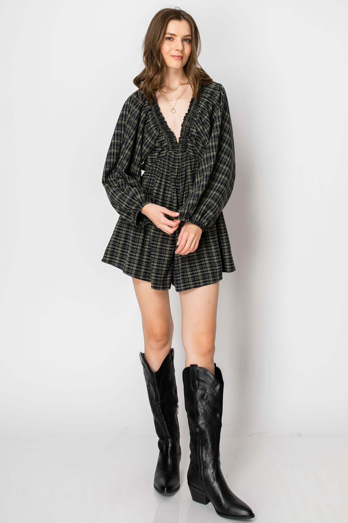 Dolman sleeve plaid smocked deep V-neck romper with pockets, oversized and comfy, styled with black boots.