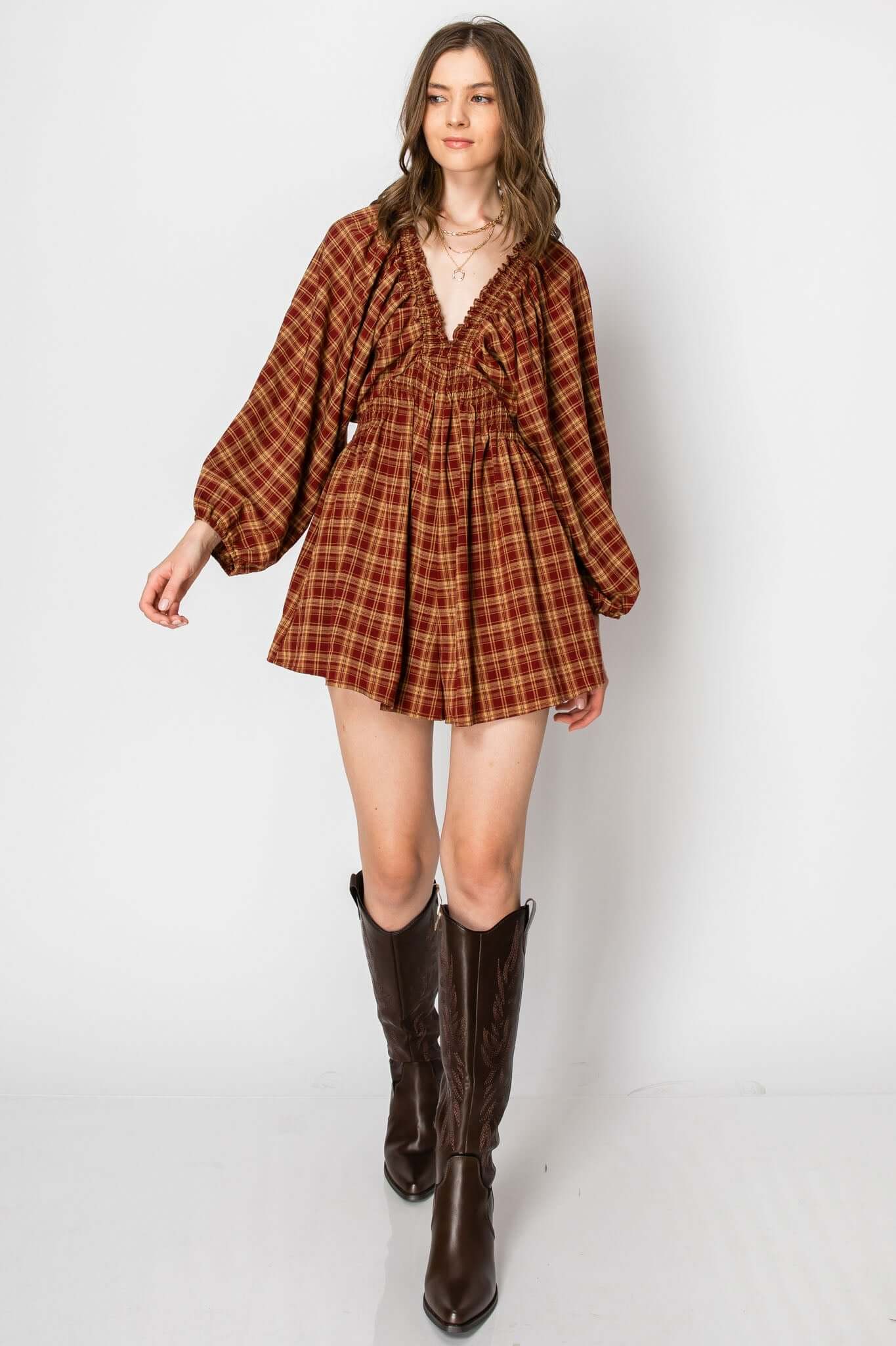 Model wearing a Dolman Sleeve Plaid Smocked Deep V Neck Romper with pockets, styled for a casual fall look.