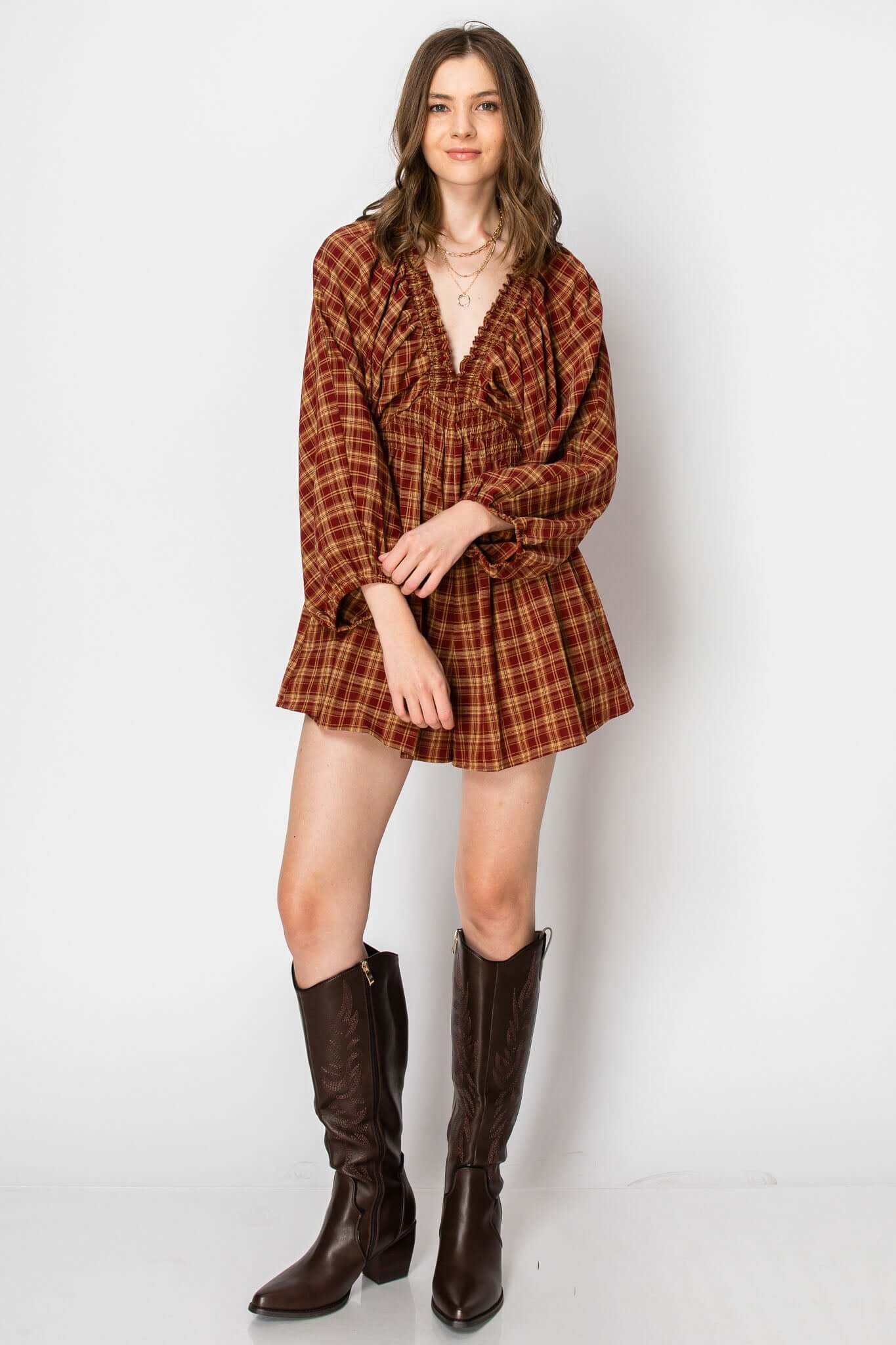 Dolman sleeve plaid smocked deep v-neck romper with pockets, perfect for fall vibes, featuring balloon sleeves and a casual fit.