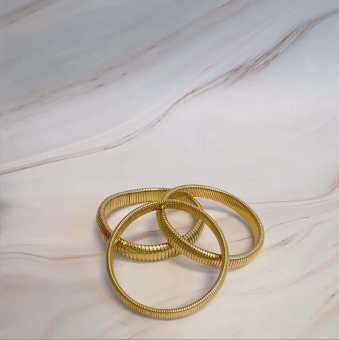 Golden Spring Soft Bangle Bracelets featuring a unique golden spring design on a stylish background.