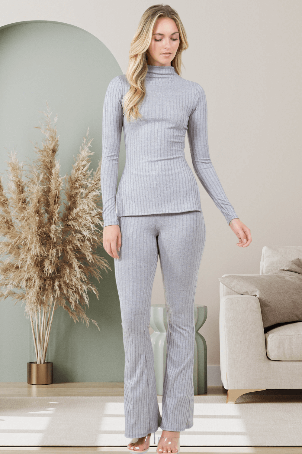 Giana 2pc Flare Pant Set in gray, featuring a high neckline top and flared pants, styled in a cozy living room setting.