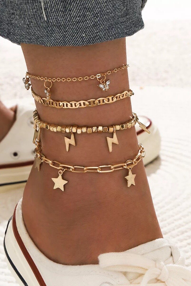 Trendy Player anklet set featuring four stylish gold-plated anklets worn together, adjustable, and perfect for layering.