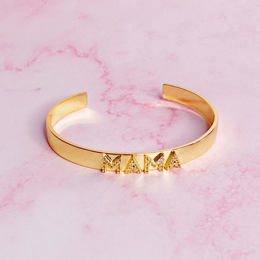 Gold plated open bangle bracelet with 'MAMA' in shiny CZs, 2.5-inch x 2-inch size, lead and nickel free.