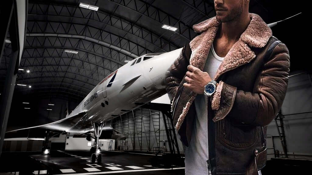 Man in bomber jacket models STROND Concorde 24h automatic watch in front of a Concorde aircraft.