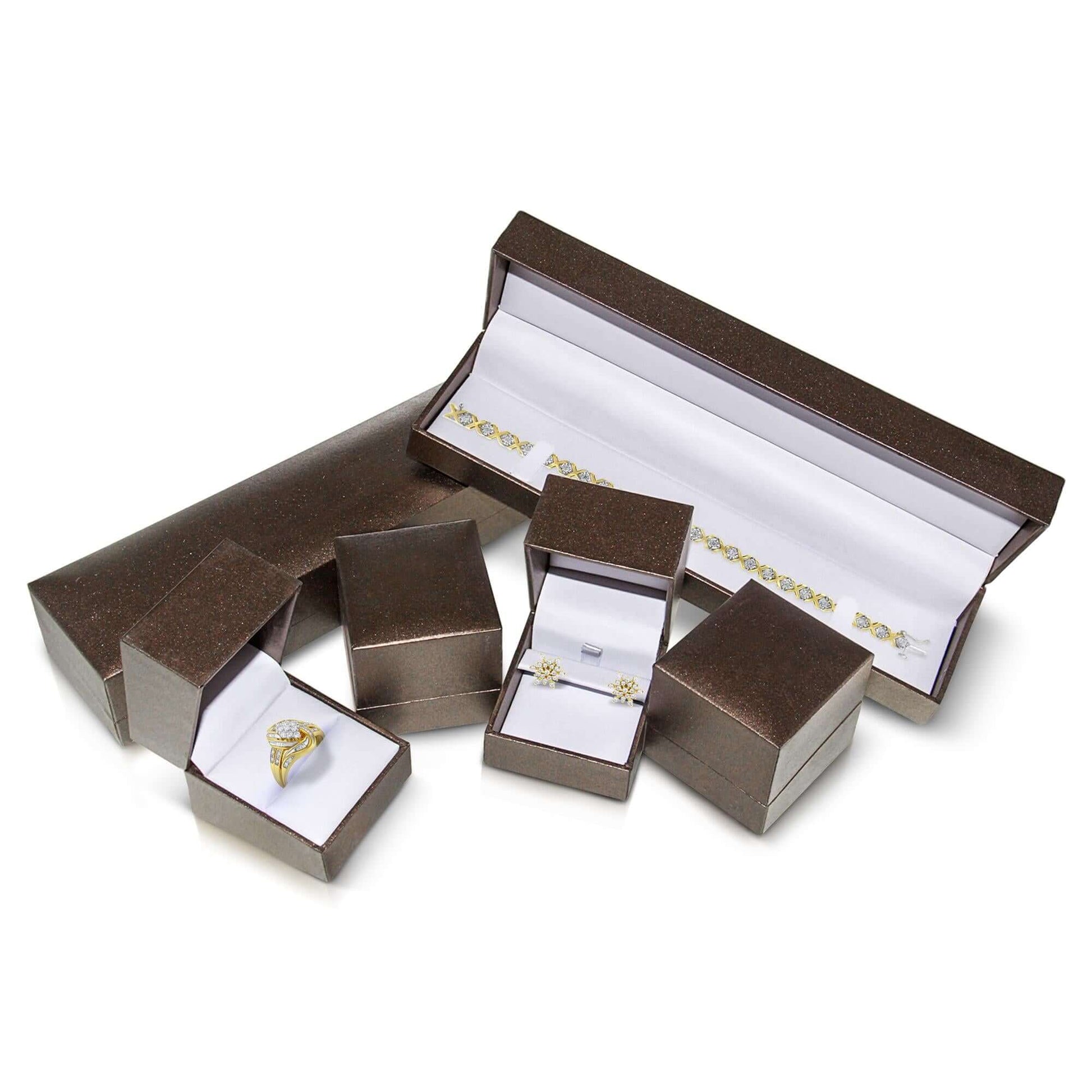 Elegant jewelry gift boxes showcasing a promise ring, earrings, and bracelet in a chic presentation.