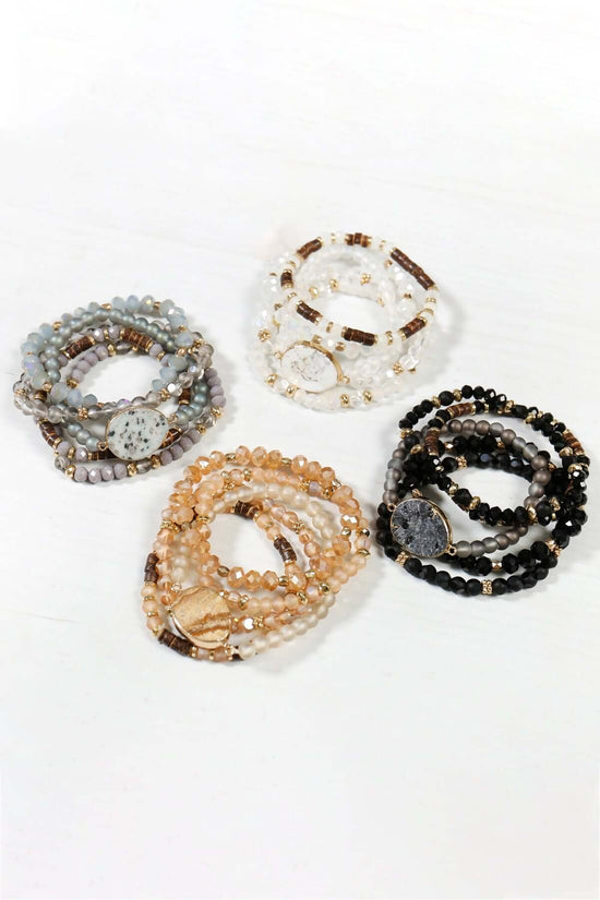 Natural stone charm mixed beads bracelets in various colors, showcasing intricate detail and charm accents.