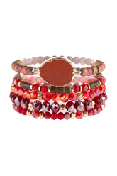 Natural stone charm mixed beads bracelets stacked with ornate etching and red glass beads.