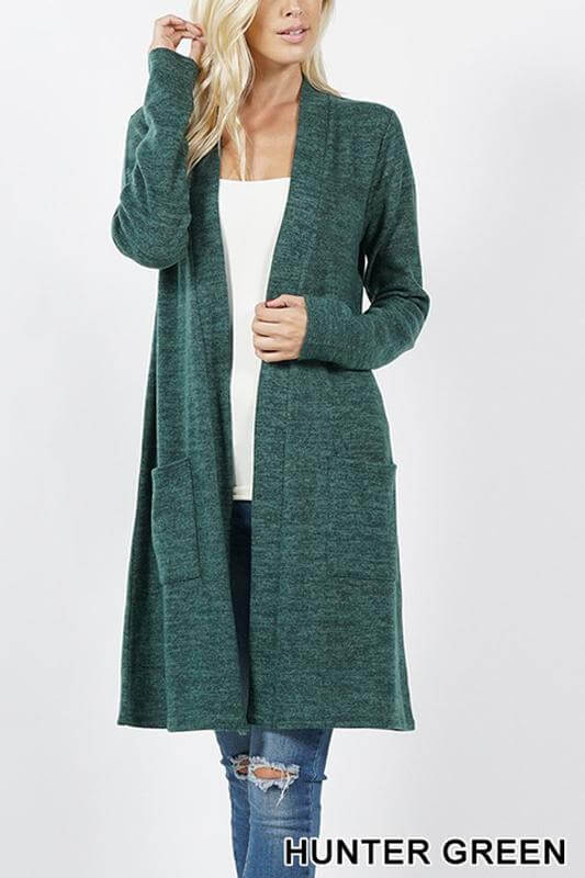 Model in a hunter green brushed sweater pocket cardigan, featuring long sleeves and an open front.